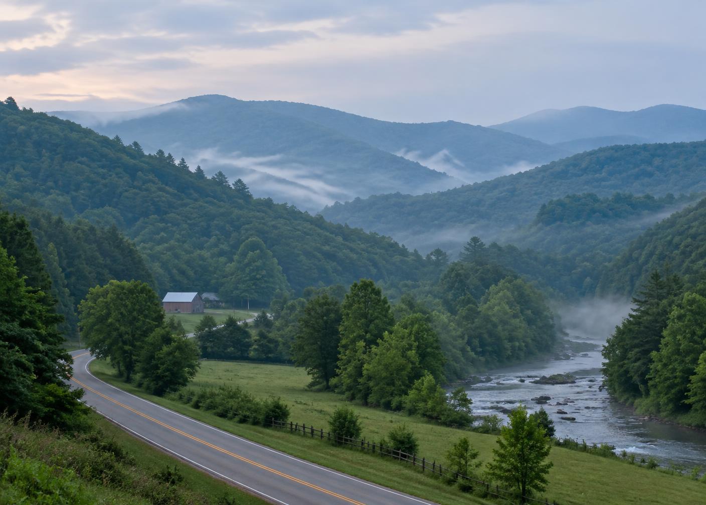 Misty forested ridges and a country road along a river valley in North Georgia